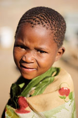 African boy in a Kalahari desert village